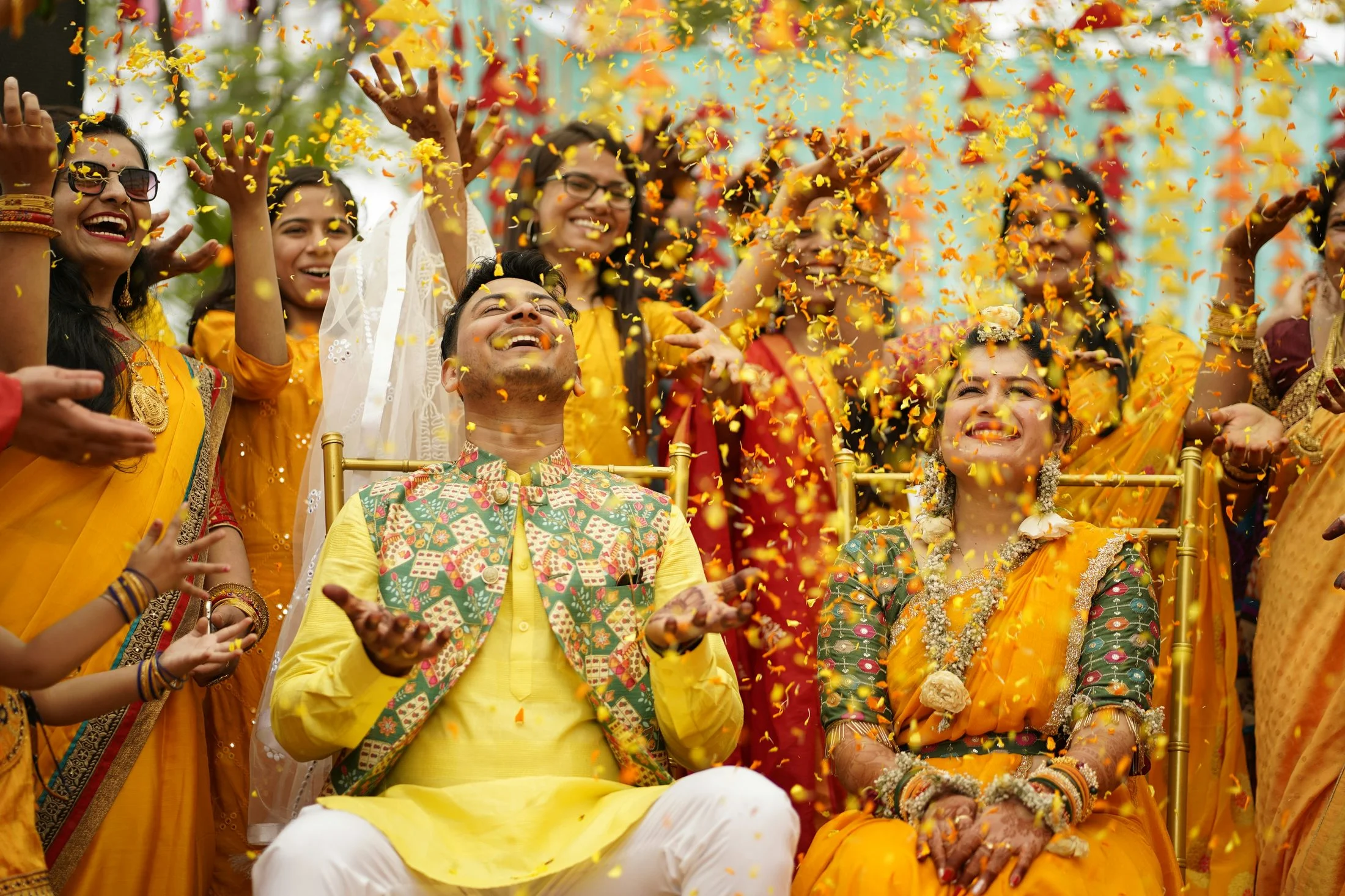 Family members applying haldi paste during a pre-wedding ceremony
